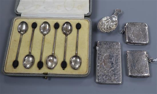 A silver caddy spoon, a silver card case, two silver vesta and a cased set of six silver bean end coffee spoons.